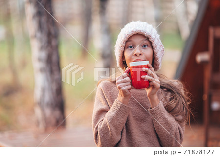 Beautiful girl wrapped in a blanket at autumn warm day Beautiful girl wrapped in a blanket at autumn warm day 71878127