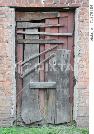 Boarded up wooden door to an old abandoned house Boarded up wooden door to an old abandoned house 71879284