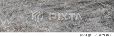Texture of cellophane material with many folds and bends Texture of cellophane material with many folds and bends 71879301