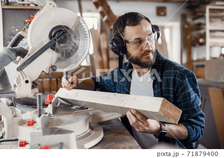 Carpenter working with circular saw 71879400