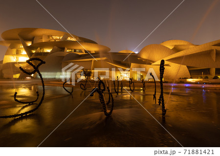 National Museum of Qatar (Desert rose) in Doha Qatar exterior night view with fountain in foreground National Museum of Qatar (Desert rose) in Doha Qatar exterior night view with fountain in foreground 71881421