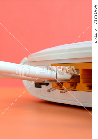 The Internet cable plugs are connected to the Internet router, which lies on a bright orange background. Items required for Internet connection The Internet cable plugs are connected to the Internet router, which lies on a bright orange background. Items required for Internet connection 71881606