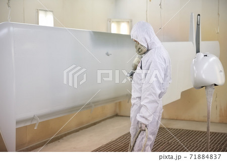 Worker in mask, airplane wing. 71884837
