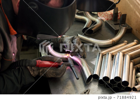 Welder at work. 71884921