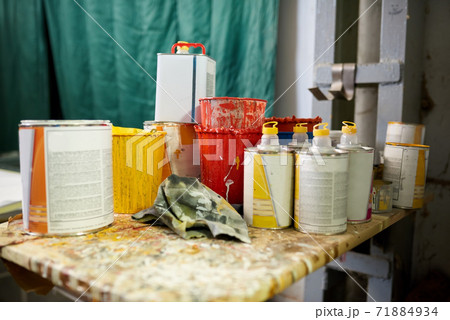 Many cans of paint and thinner. 71884934