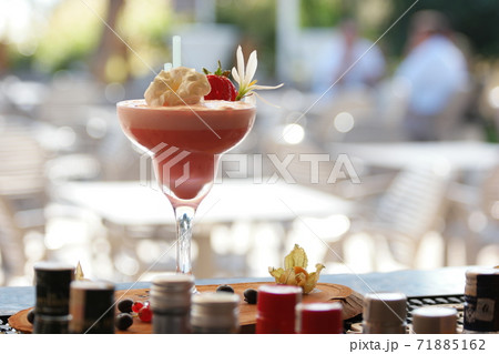 Milk cocktail decorated with strawberry and flower. Milk cocktail decorated with strawberry and flower. 71885162