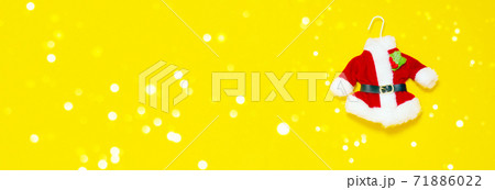 Christmas banner. Santas red suit on yellow background. Christmas banner. Santas red suit on yellow background. 71886022