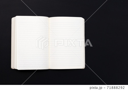 Open notebook on dark background. Top view Open notebook on dark background. Top view 71888292