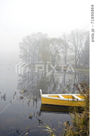 autumn lake landscape with boat and mist 71890869