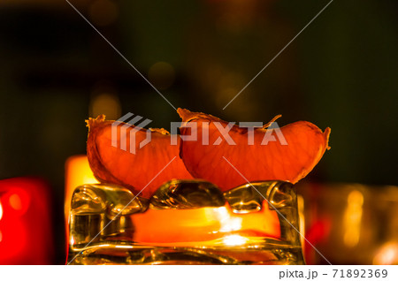 Still life with candles and orange slices. On dark background. Romantic new year mood 71892369
