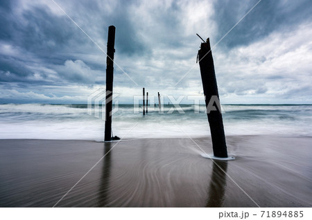 Big wave hitting a decay wooden bridge on the beach in stormy weather at Pilai beach, Phang nga Big wave hitting a decay wooden bridge on the beach in stormy weather at Pilai beach, Phang nga 71894885