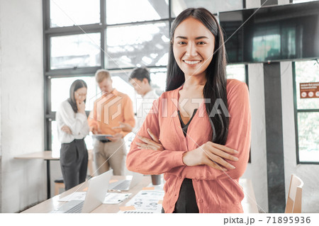 Young businesswoman standing with document near the office window, business concept 71895936