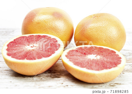 Grapefruit isolated on wooden table. Freshly harvested grapefruit Grapefruit isolated on wooden table. Freshly harvested grapefruit 71898285
