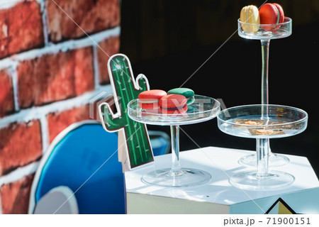 Sweet red macaroon on a glass stand. Gift for Valentine's Day 71900151