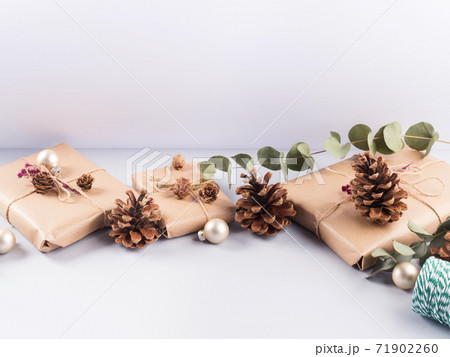 Christmas festive wrapped presents, pine cones Christmas festive wrapped presents, pine cones 71902260