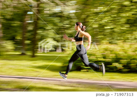 Motion blur of woman's training in park. Motion blur of woman's training in park. 71907313