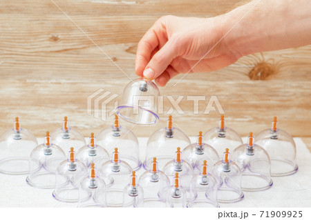 Hand takes vacuum glass jar. Hand takes vacuum glass jar. 71909925