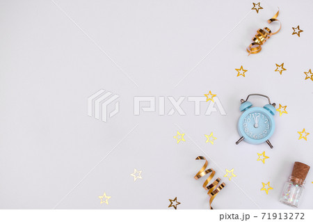 Christmas composition. blue alarm clock, Golden snowflakes, layout on a white background. 71913272