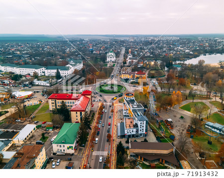 Aerial view of roundabout road with circular cars in small european city at autumn cloudy day Aerial view of roundabout road with circular cars in small european city at autumn cloudy day 71913432