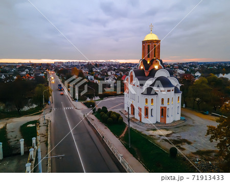 HDR aerial view of old church near river and bridge in small european city at epic sunset HDR aerial view of old church near river and bridge in small european city at epic sunset 71913433