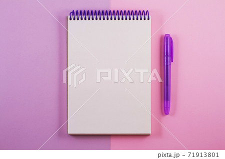 A white notepad on a double light purple background. A white notepad on a double light purple background. 71913801