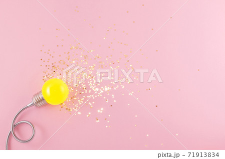 One yellow decorative lamp on a light pink background. One yellow decorative lamp on a light pink background. 71913834