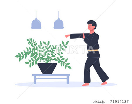 Man practicing martial arts wearing black kimono with yellow belt. Guy training at home or in studio, exercising Man practicing martial arts wearing black kimono with yellow belt. Guy training at home or in studio, exercising 71914187