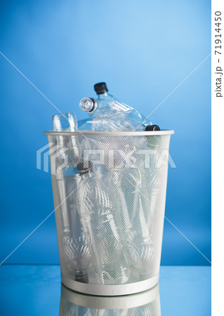trash can with wasted plastic bottles, blue background trash can with wasted plastic bottles, blue background 71914450