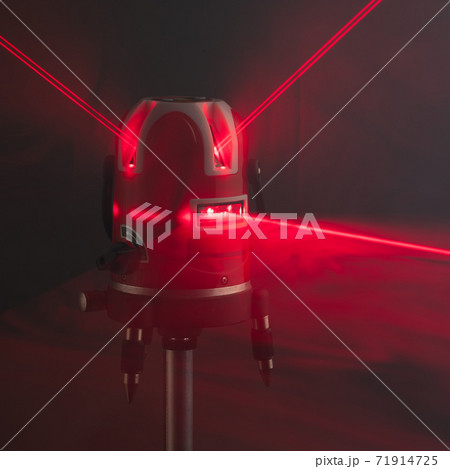 laser level tool red light beams in smoke 71914725