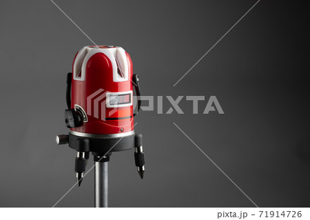 red laser level tool on grey background 71914726