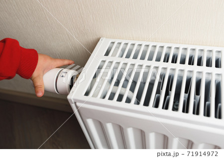 child hand controls thermostatic knob of heating radiator child hand controls thermostatic knob of heating radiator 71914972