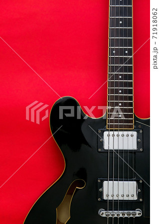 Electric Guitar on a red 71918062