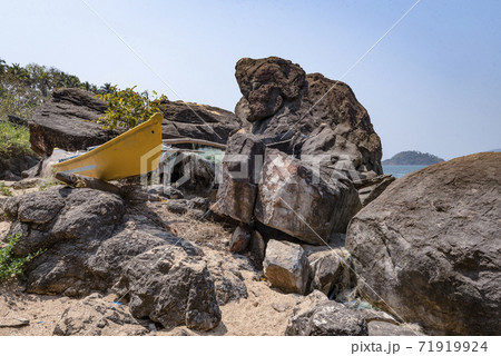 Yellow fishing boat and nets on the rocky shore of the Indian ocean Yellow fishing boat and nets on the rocky shore of the Indian ocean 71919924