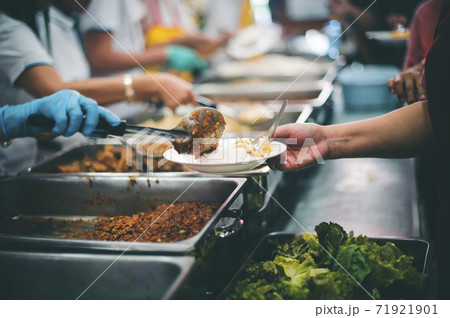 Starving homeless people receive food from volunteers who serve humane 71921901