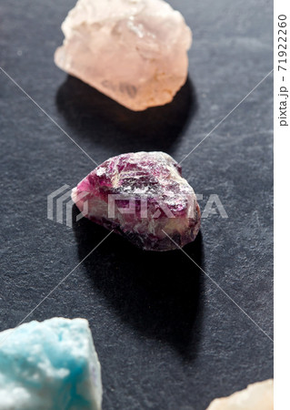quartz crystals and gem stones on slate background quartz crystals and gem stones on slate background 71922260