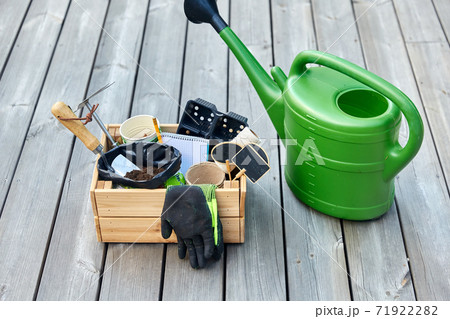 box with garden tools and watering can in summer 71922282
