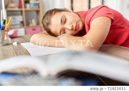 tired student girl sleeping on table at home tired student girl sleeping on table at home 71923031