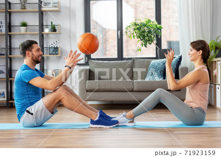 happy couple exercising with ball at home 71923159