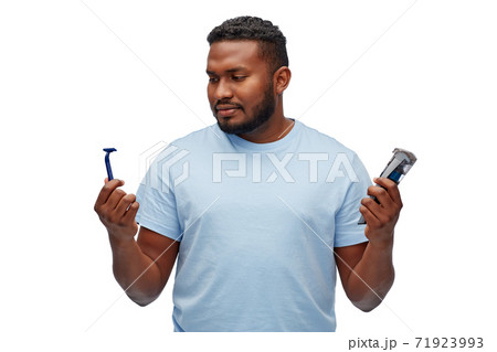 african man with razor blade and trimmer african man with razor blade and trimmer 71923993