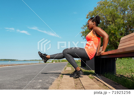 african american woman doing sports at seaside 71925256