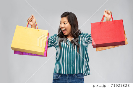 happy asian woman with shopping bags 71925328