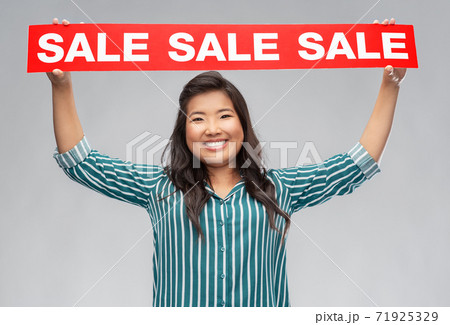 happy smiling young asian woman with sale banner happy smiling young asian woman with sale banner 71925329