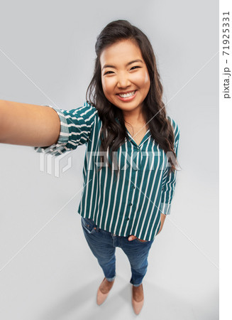 happy smiling asian woman taking selfie happy smiling asian woman taking selfie 71925331