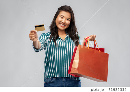 asian woman with shopping bags and credit card asian woman with shopping bags and credit card 71925333