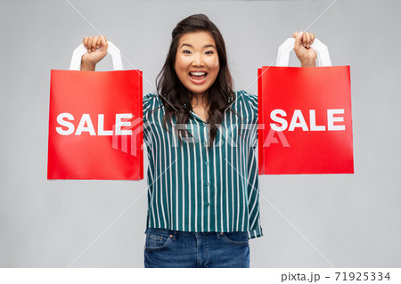 happy asian woman with shopping bags happy asian woman with shopping bags 71925334
