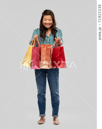 happy asian woman with shopping bags happy asian woman with shopping bags 71925336