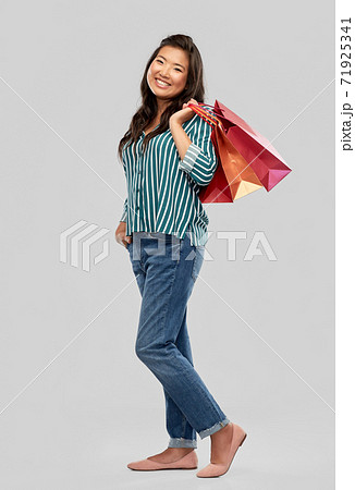 happy asian woman with shopping bags 71925341