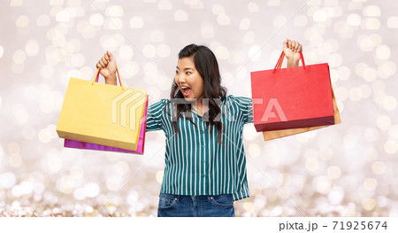 happy asian woman with shopping bags happy asian woman with shopping bags 71925674