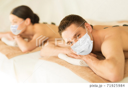 couple in masks at spa 71925984