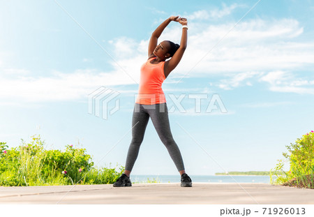 young african american woman exercising on beach young african american woman exercising on beach 71926013